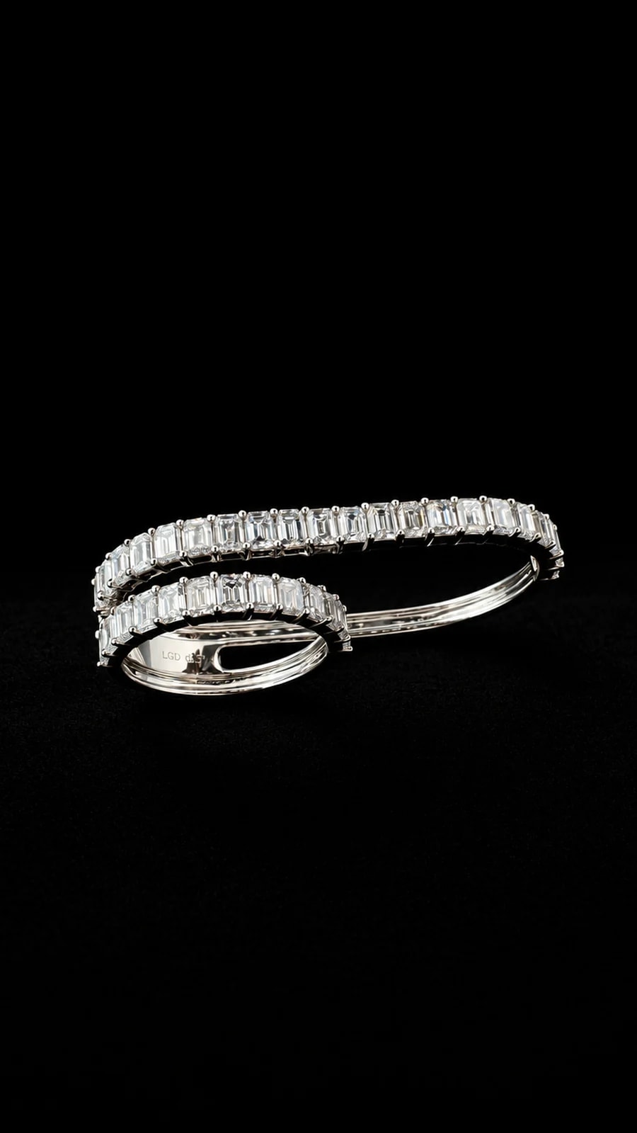 Sculptural dual diamond ring on a black background